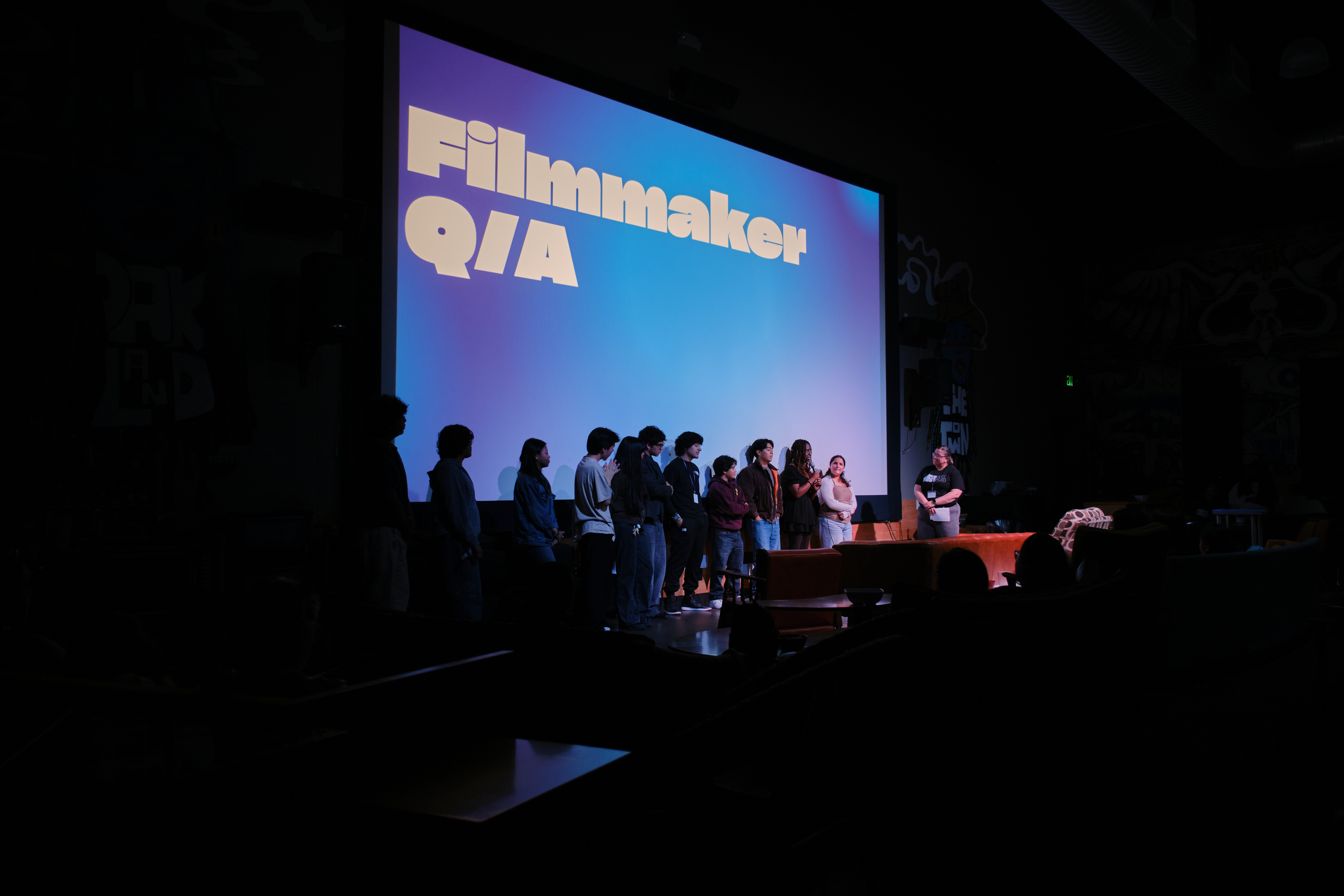 REEL students on stage for a Filmmaker Q&A at a film screening